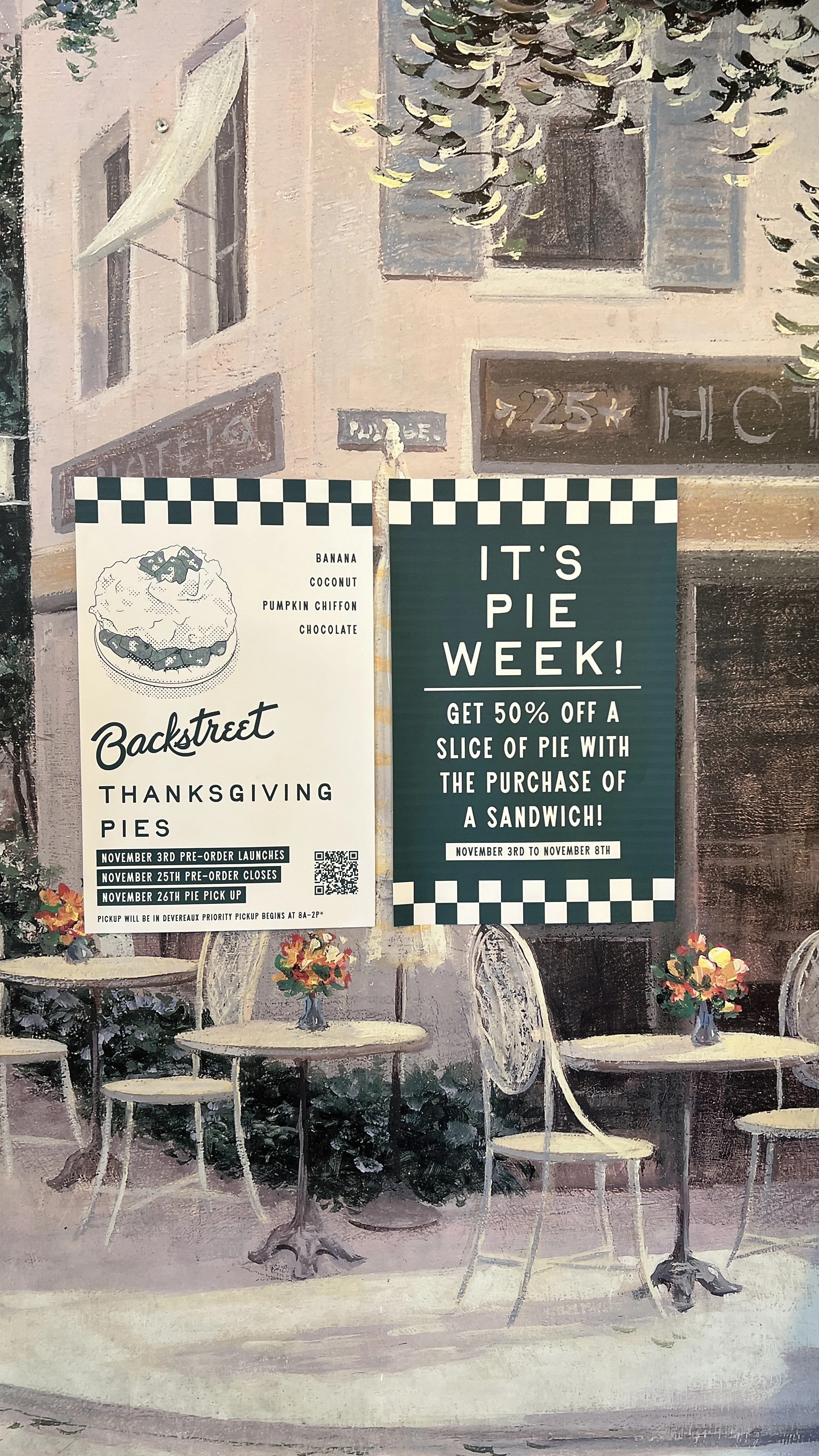 Painted outdoor café scene with tables, chairs, and flower arrangements. Two posters advertise Thanksgiving pies and a pie week promotion, with details about pre-order dates and discounts.