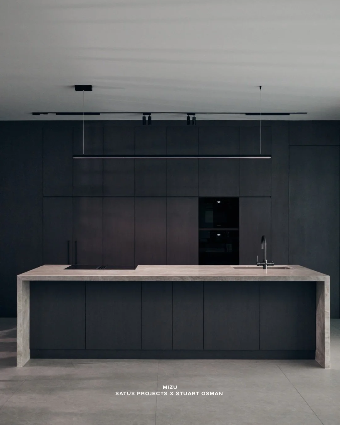 Holding the core.

In a darker kitchen, the island carries the room. Taj Mahal stone drawn down in a full waterfall, grounding the space with quiet weight. Soft movement in the stone, set against deep joinery, balanced, not competing.

At MIZU, it&rs