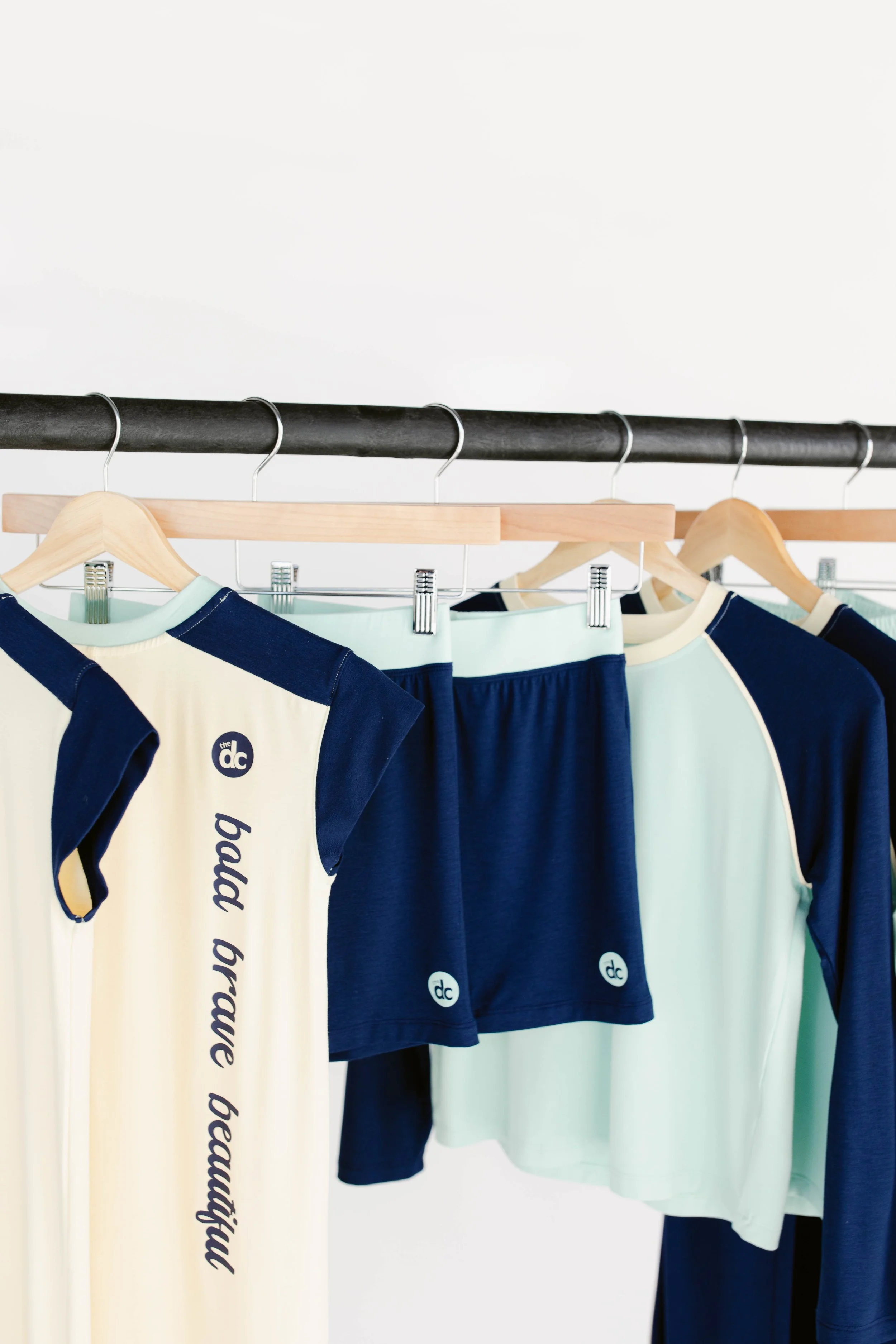 The Decided Collection products hanging on a clothing rack