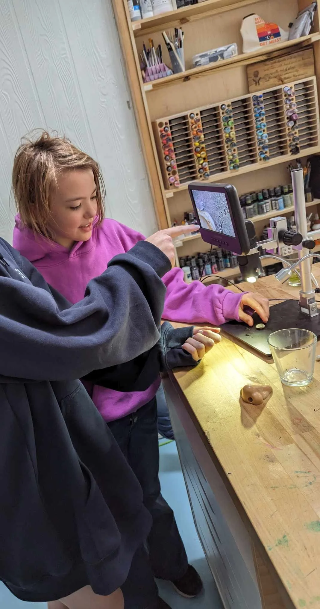 Students examining specimens with a microscope