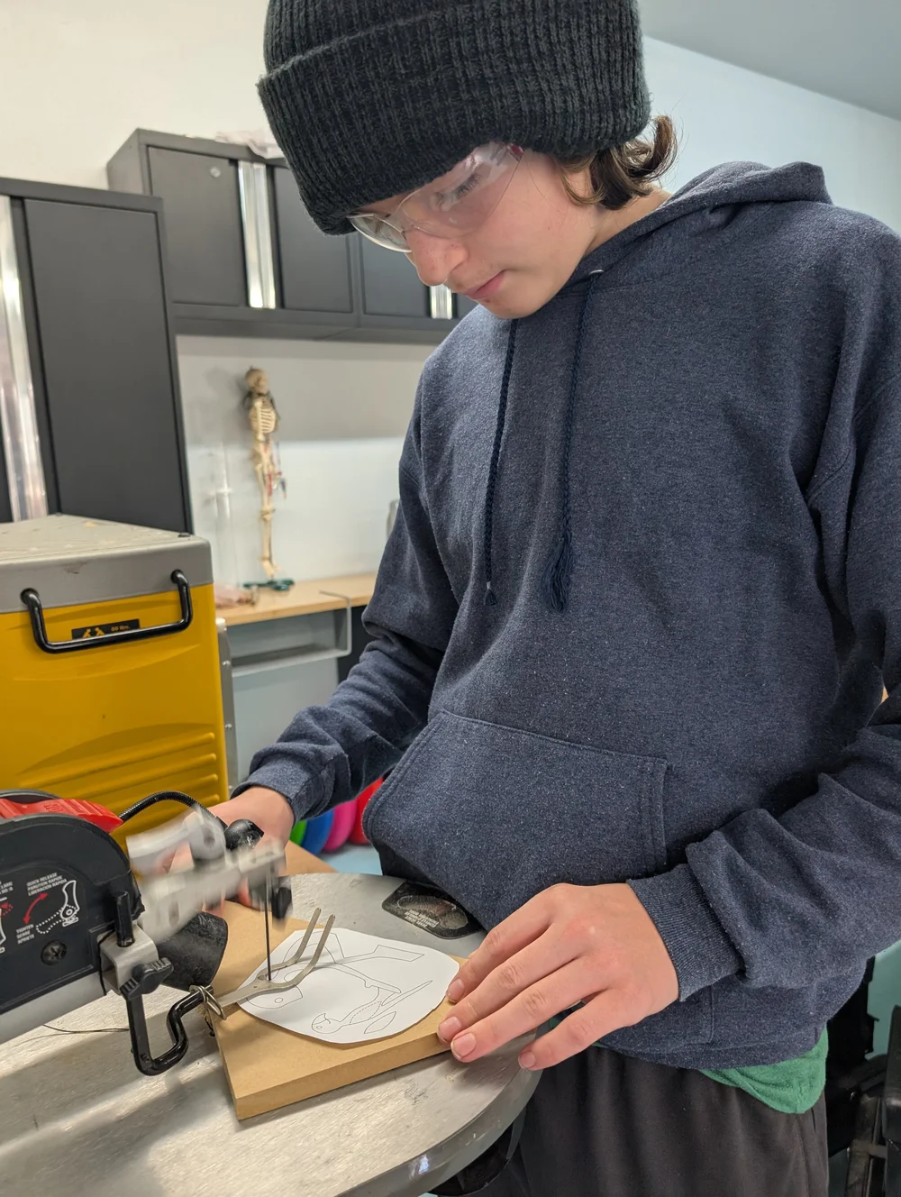 A student working with materials at a table