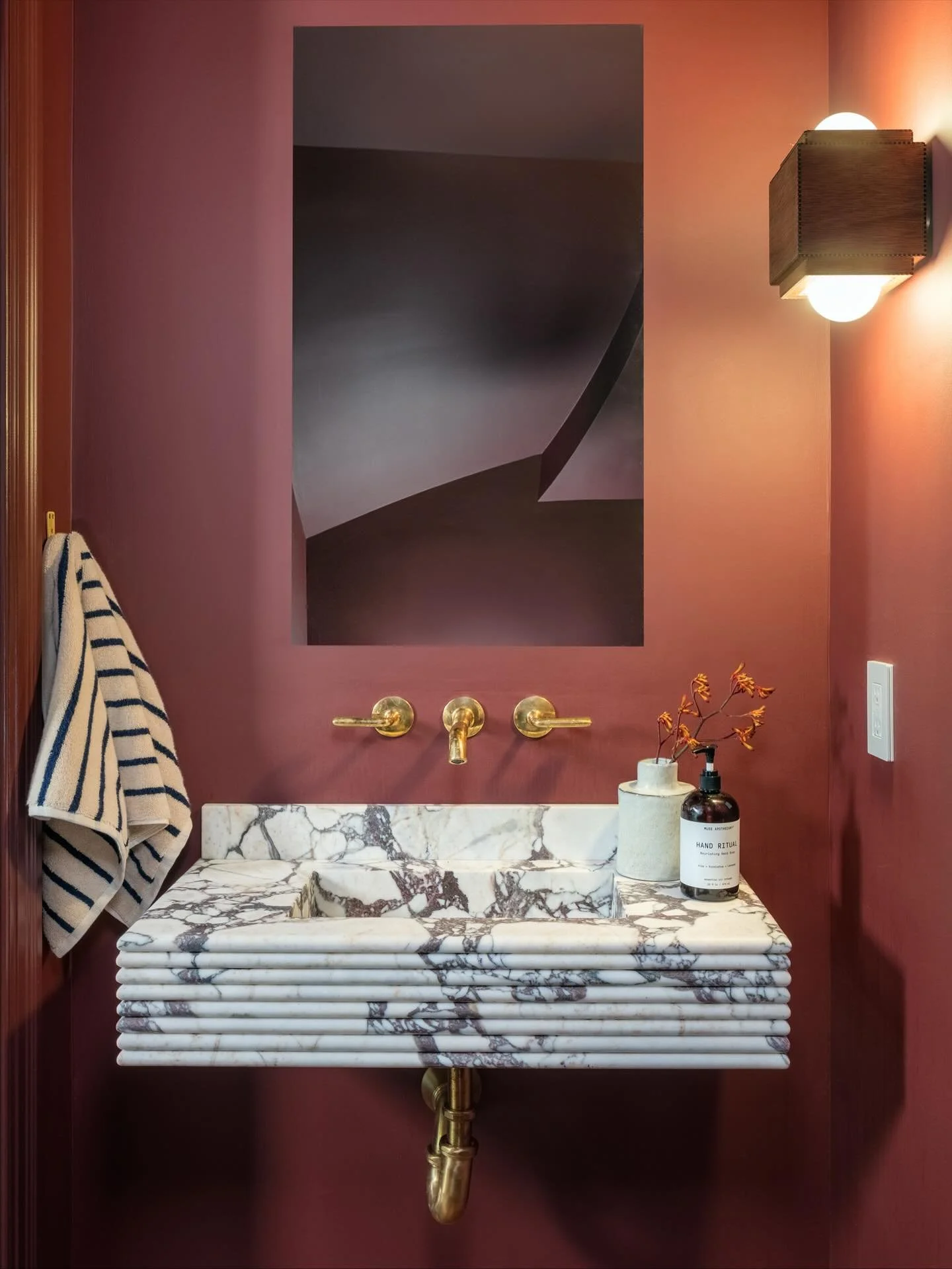 Hand crafted floating vanity using 8 pieces of stacked calacatta viola.  We wanted something weird and wonderful at this teeny powder and I think we nailed it. @dushi_marble @loparcoassociates