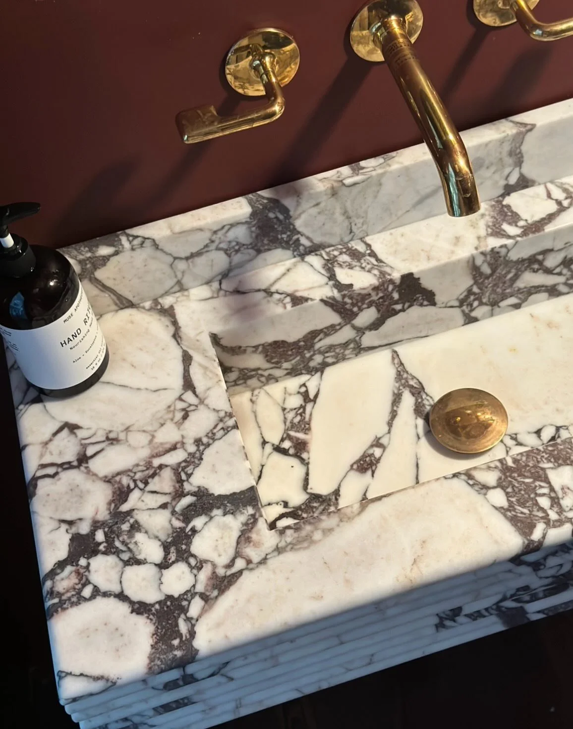 Snuck in this fierce little calacatta viola custom sink under the stairs.  Eight layers of stone stacked with bullnose edge and integrated sink produced perfectly by @dushi_marble and @loparcoassociates