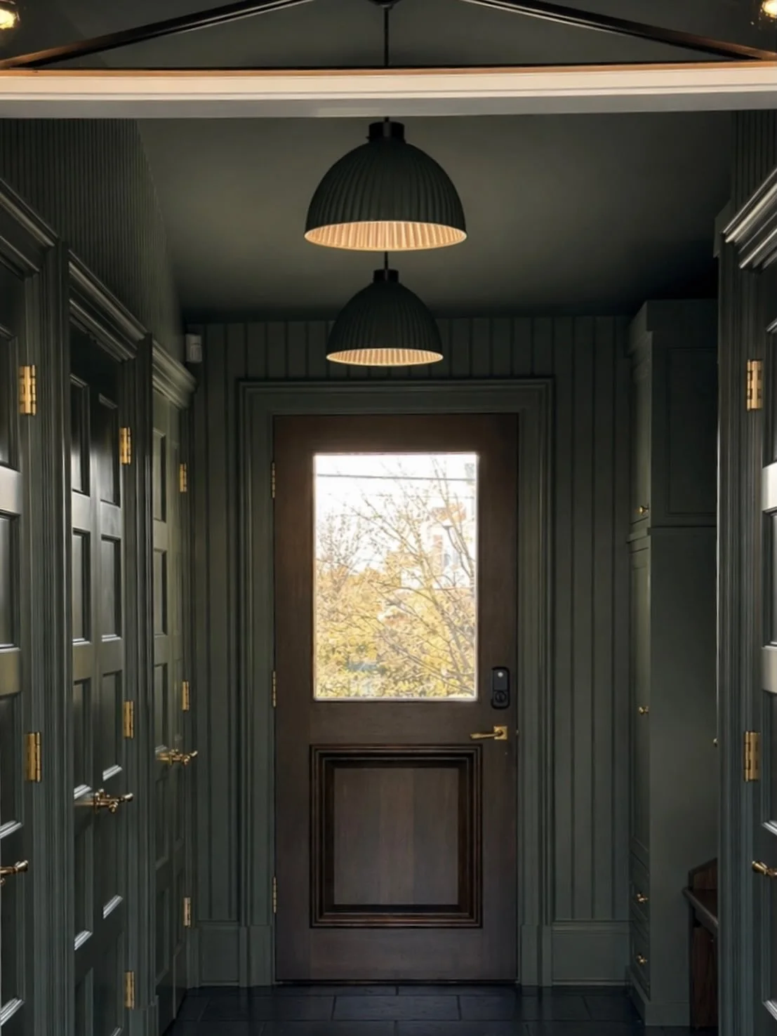 A flashback to one of my favorite mudrooms.  Dark but welcoming with belgian bluestone floors by @parisceramicsusa , custom millwork, @classicbrass hardware and some tonal beauties by @hectorfinchlighting