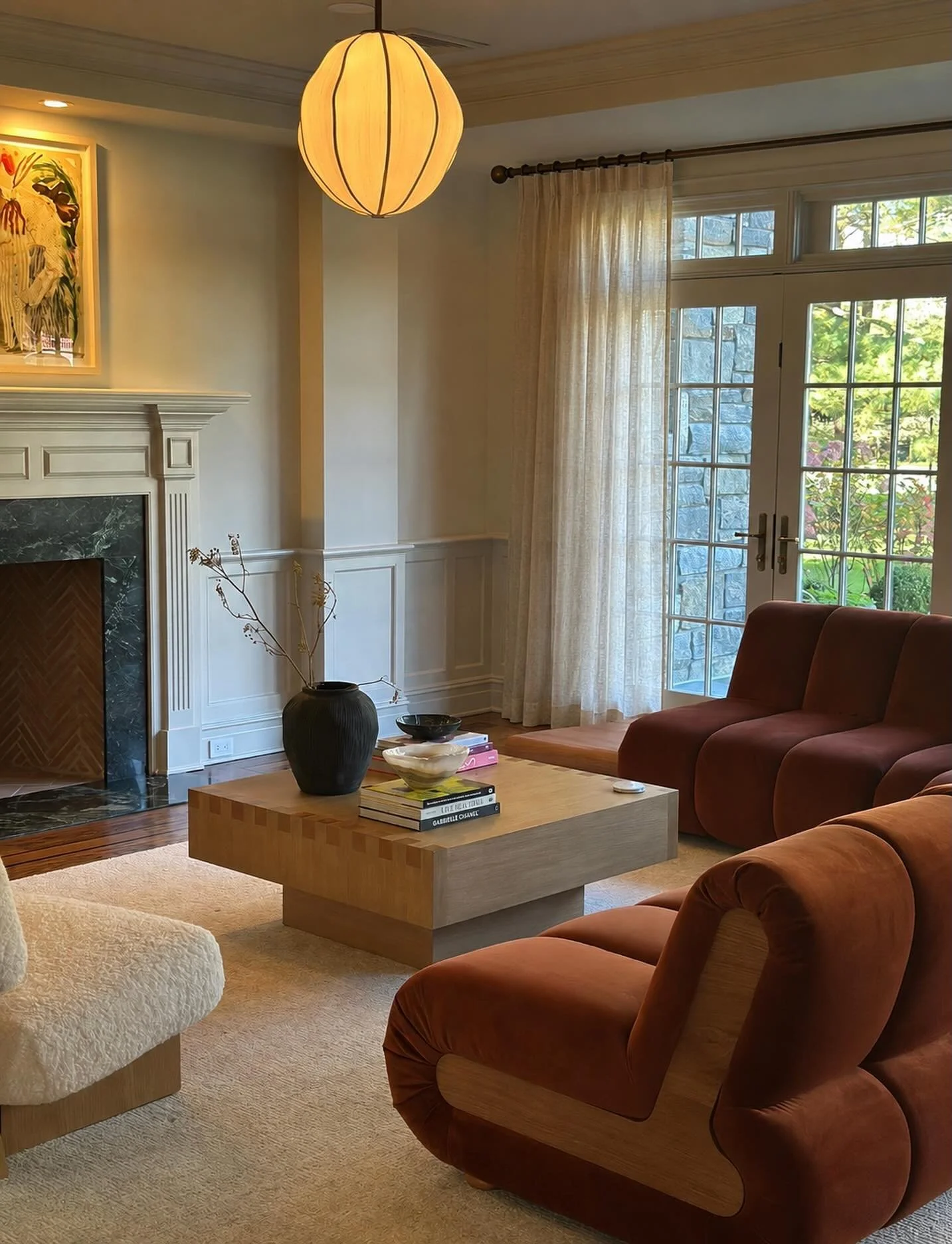 A classic Georgian interior renewed for a modern, youthful family.  Pendant by @annakarlinstudio grounds the sinuous lounge around the fireplace.