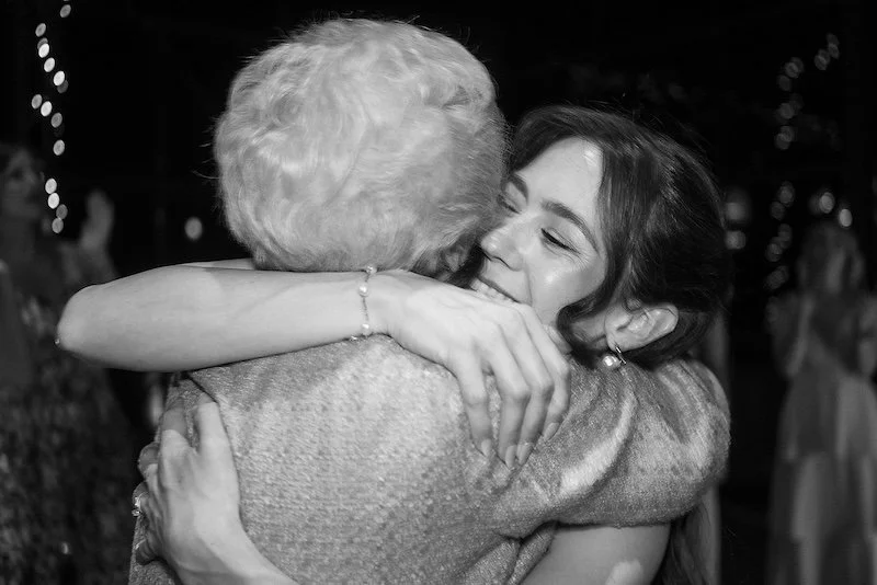 Bride shares a quiet, emotional moment with her grandmother during the wedding.