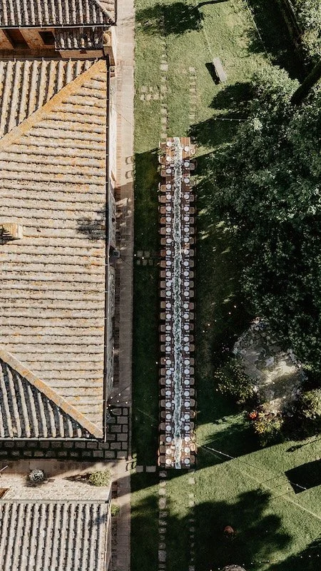 Luftaufnahme der langen Hochzeitstafel im Garten des Agriturismo Belagaggio.