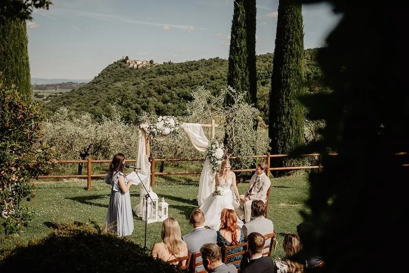Outdoor wedding ceremony at a Tuscan villa with panoramic views over the rolling hills of Tuscany.