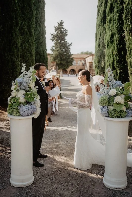 A non-religious wedding ceremony among columns of flowers in the cypress-lined avenue of Villa Boscarello