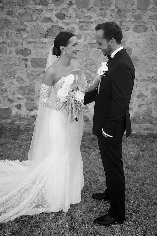The bride and groom during their "first look" in front of the historic wall of Villa Boscarello