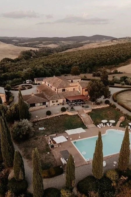 Aerial view of Villa Boscarello in Tuscany with wedding guests by the pool