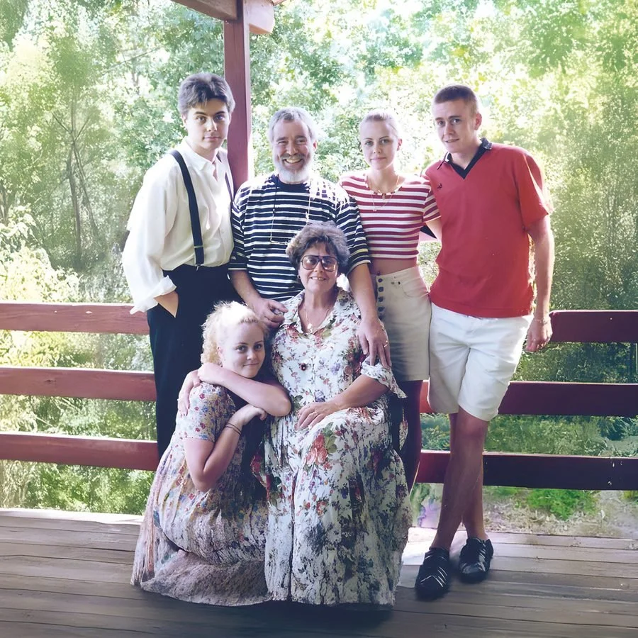 The Drury family, including Christopher, together on a timber verandah in 1996