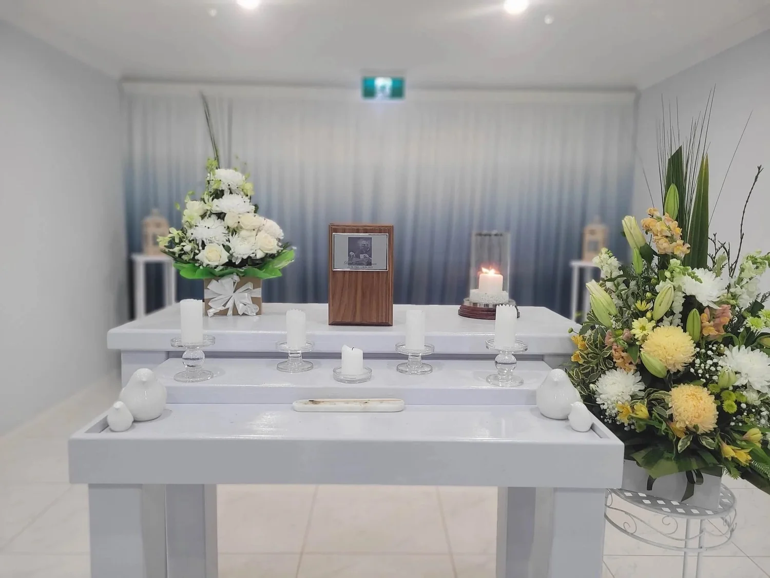 A quiet room prepared with flowers for a family farewell