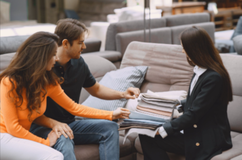 Couple choosing fabric samples for reliable upholstery at Maui Upholstery Services Boats and Furniture showroom