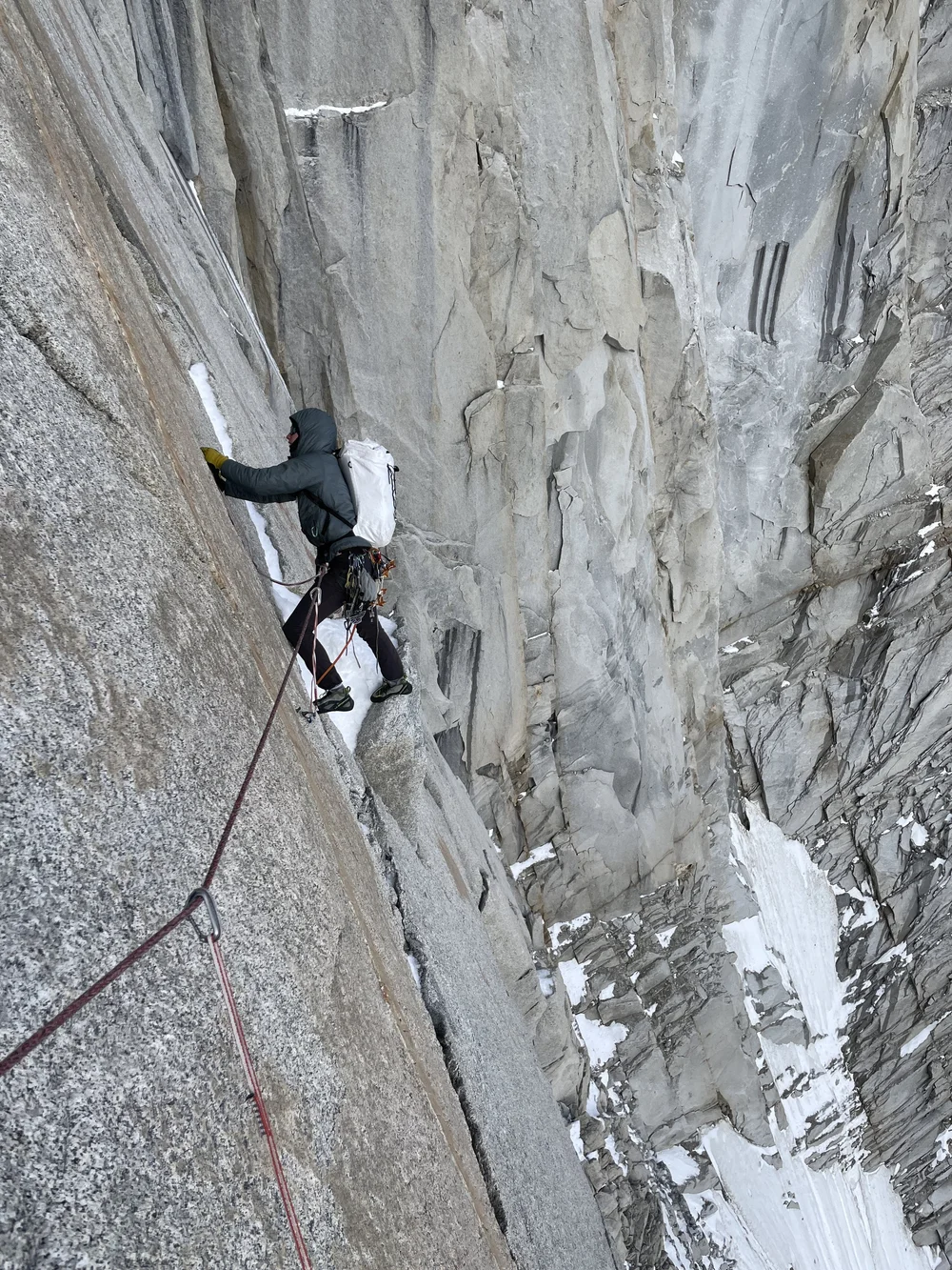 Cleaning a piece of gear on the first or second pitch of rock (Photo: Colin Haley)