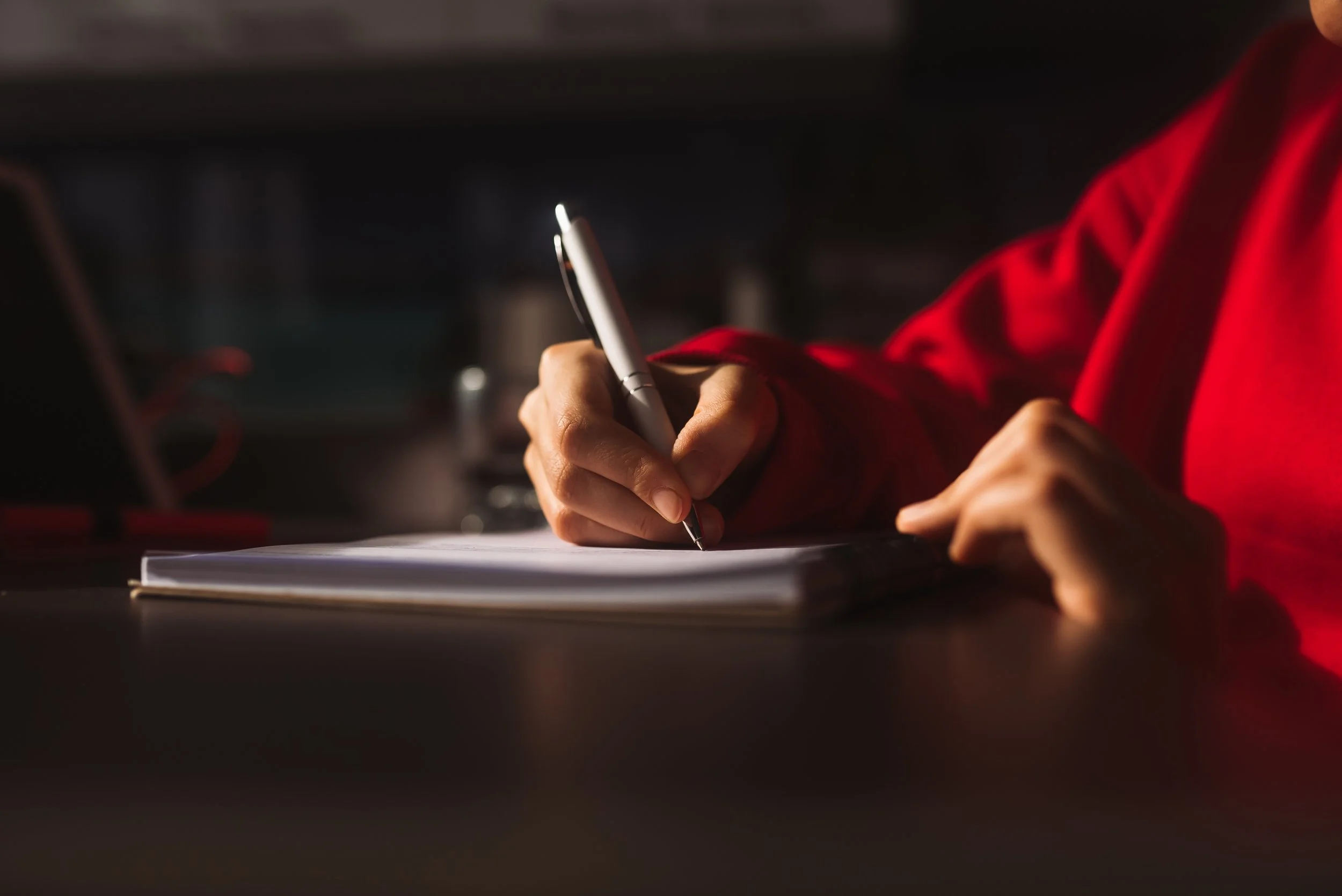 Image of a woman writing for making a start on a script