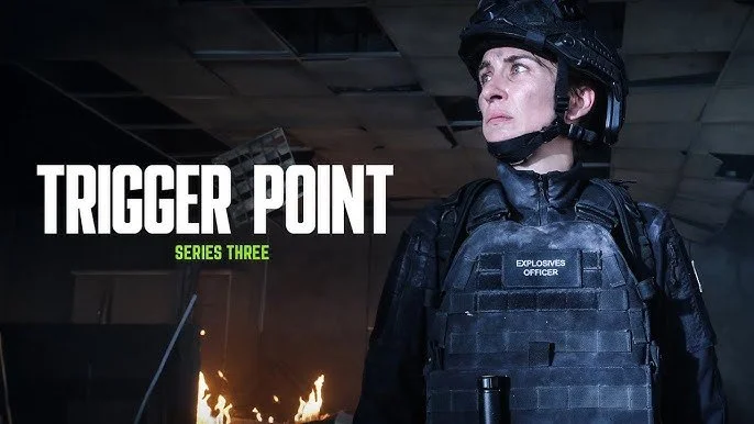 Person dressed as a bomb squad officer in tactical gear, standing in a dark room with fire in the background, with the text "Trigger Point Series Three" on the left.