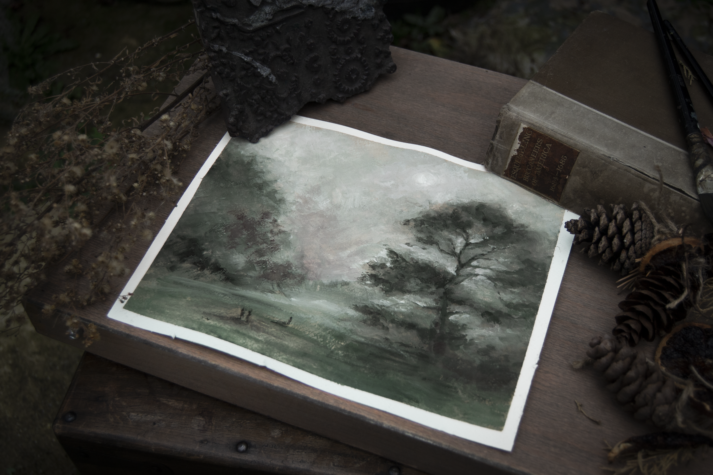 Gouache painting of a tall tree in the mist. Eerie, moody, atmosphere. Dominant colour is green. Calm but dark countryside.