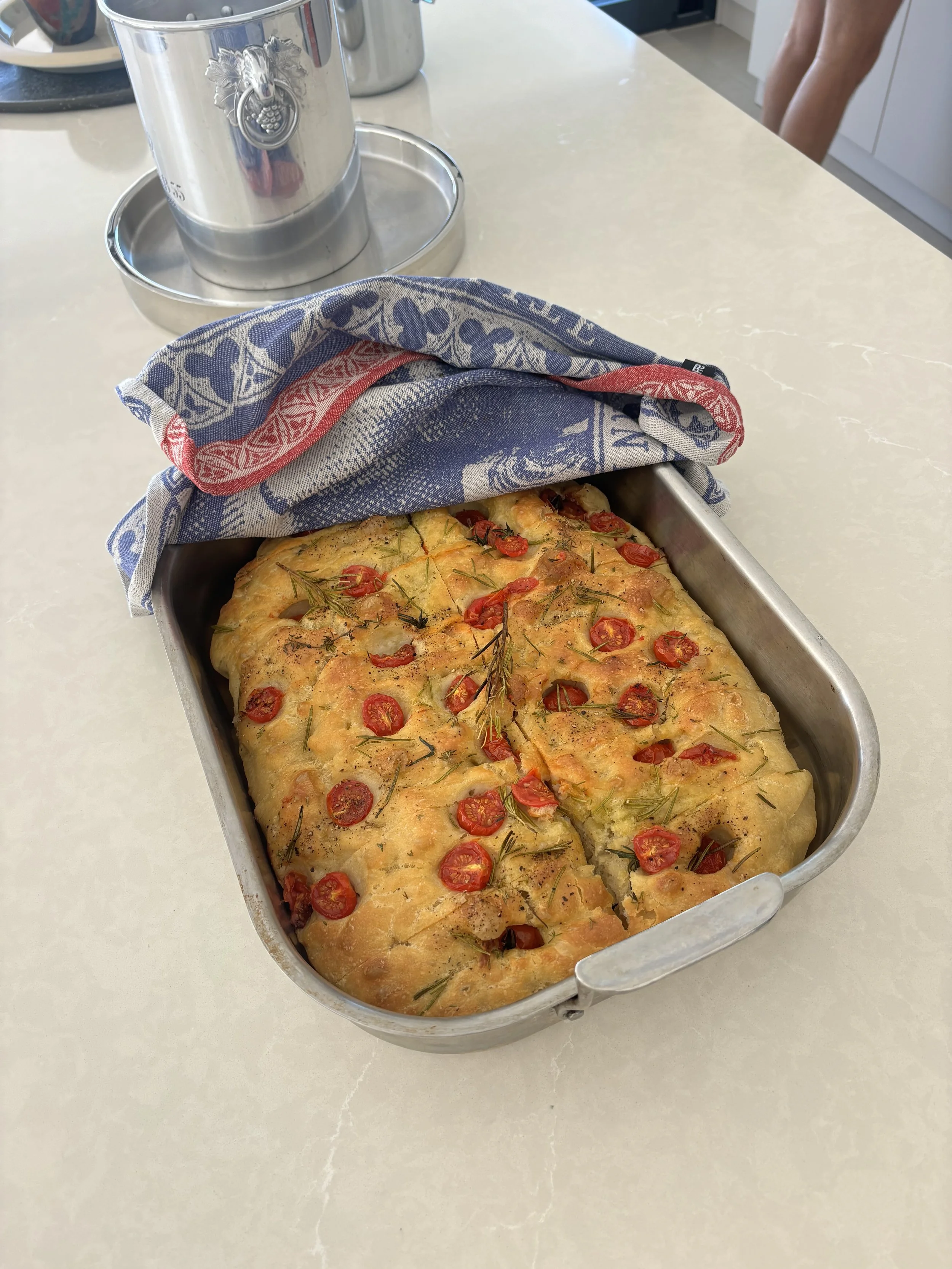 Rosemary and Cherry Tomato Focaccia
  Artisan focaccia made with slow-fermented dough, topped with blistered cherry tomatoes and fresh rosemary, and finished with extra-virgin olive oil and flaky sea salt.