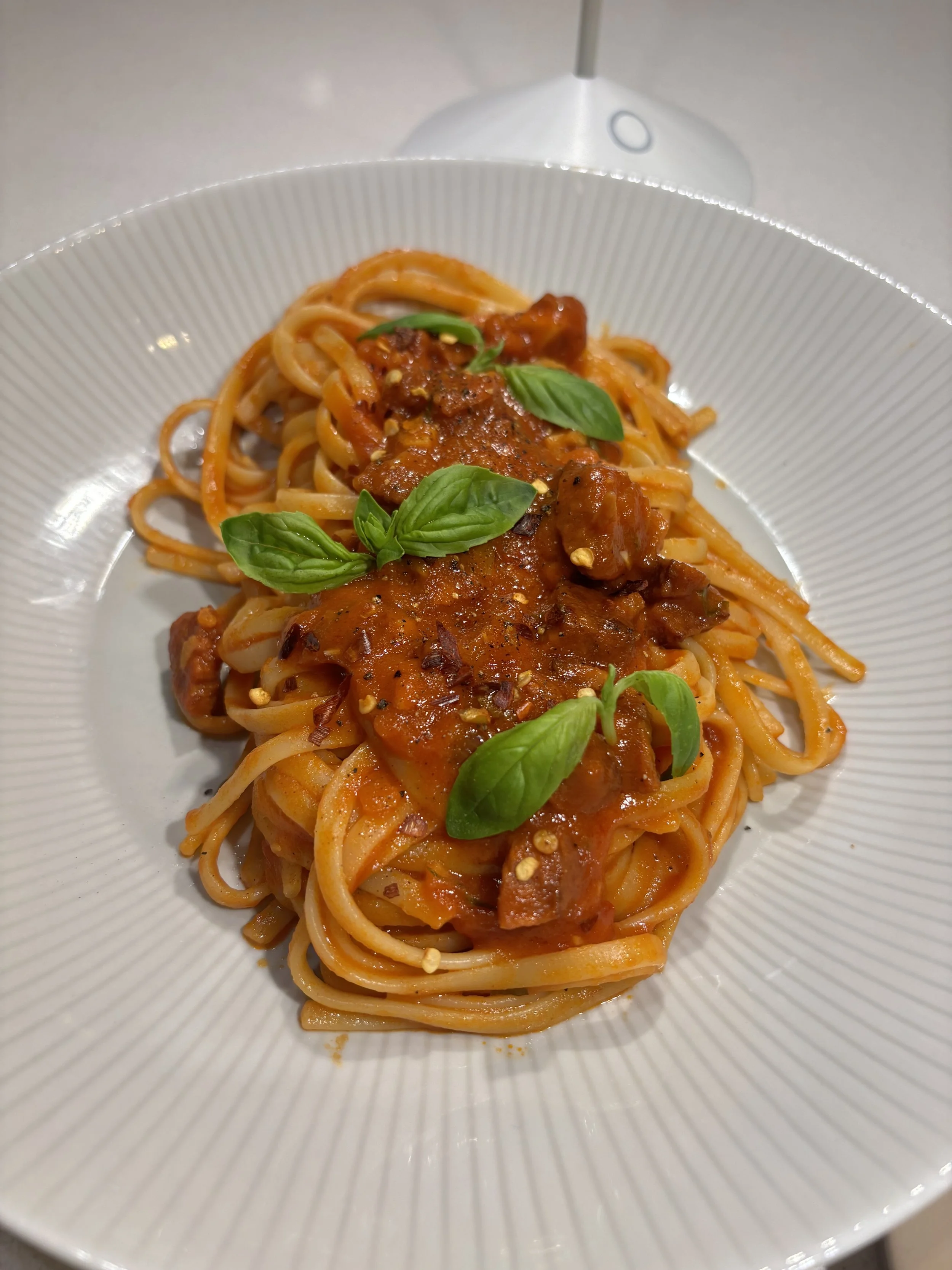Linguine Arrabbiata with Chorizo  Linguine tossed in spicy tomato sauce with chorizo, garlic, chili flakes, and fresh basil, finished with extra-virgin olive oil.