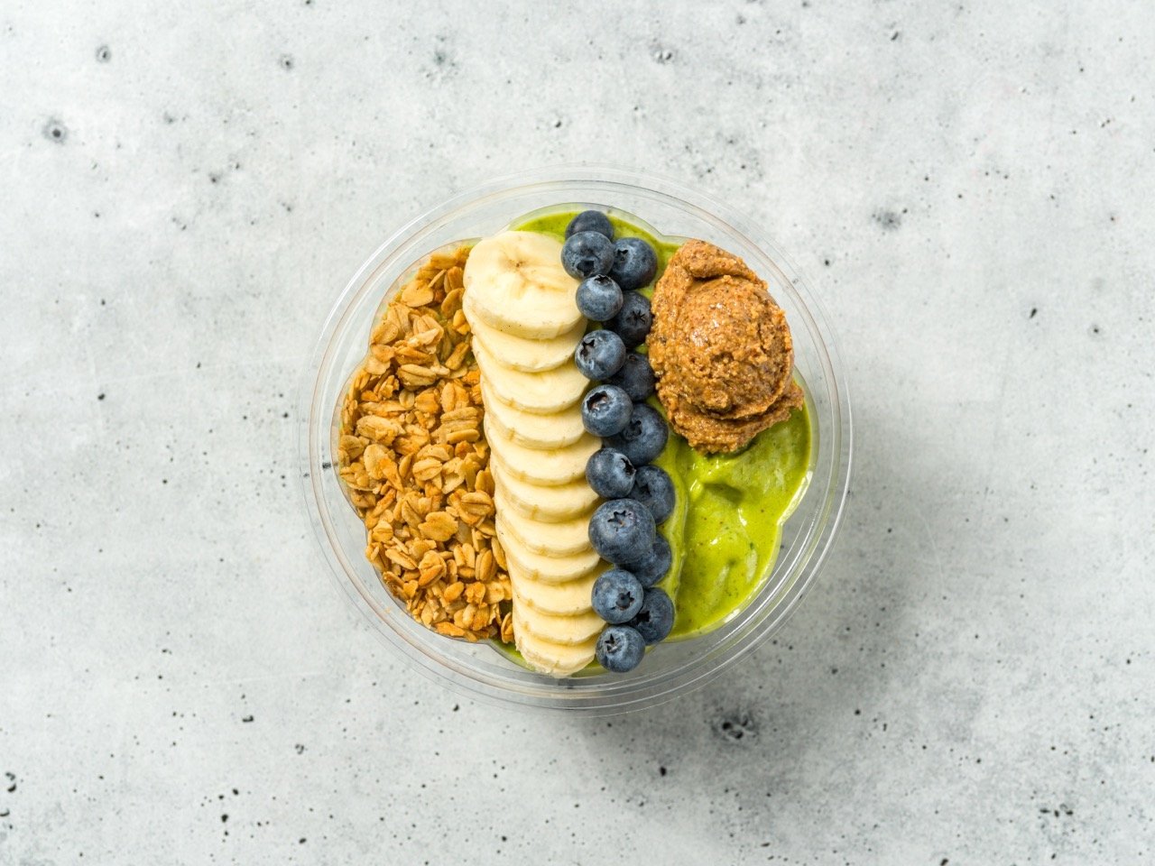  A scoop of peanut butter completes the arrangement on the smoothie bowl. 