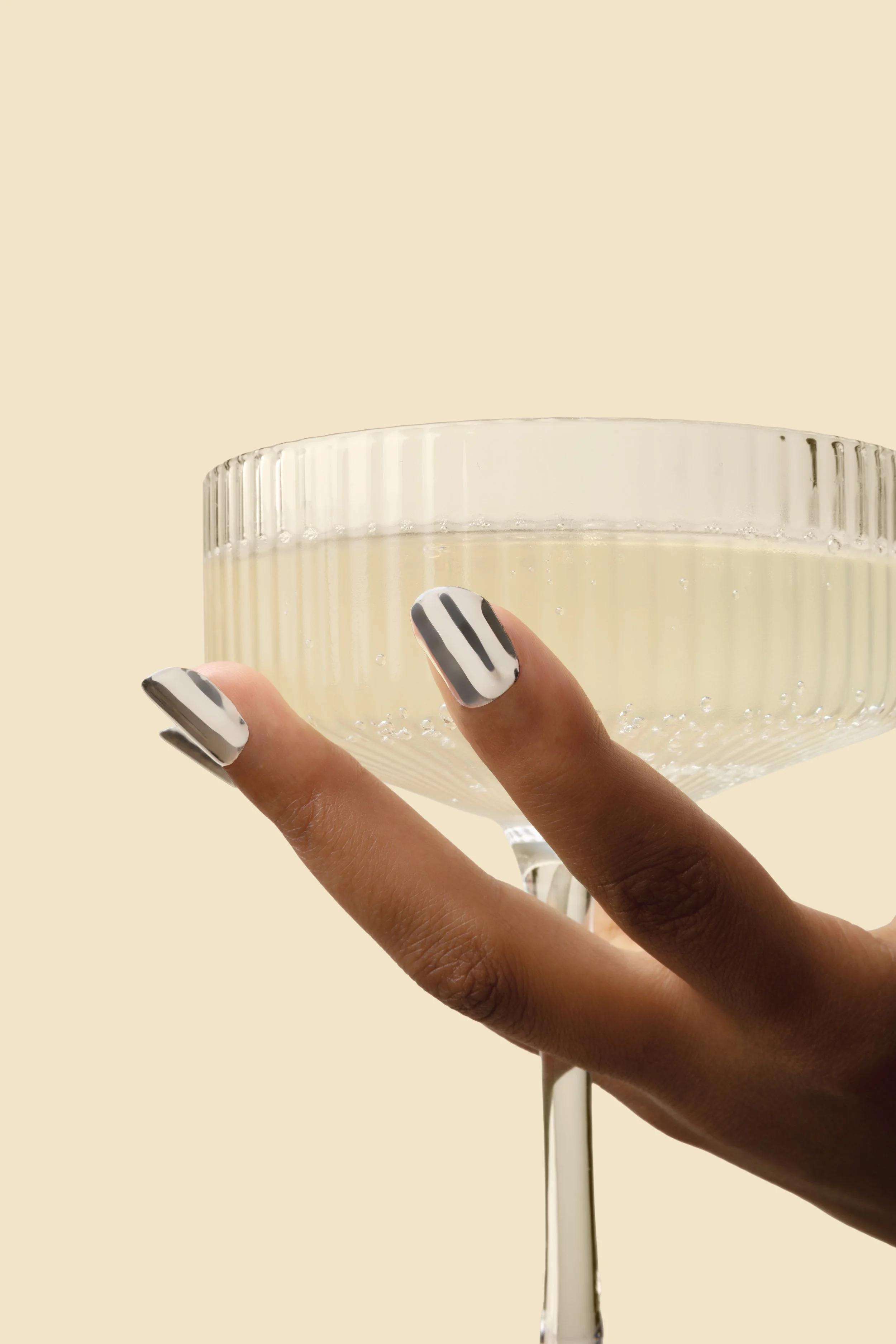 model wearing 14k white gold nails with glass, mirror finish, soft square shape