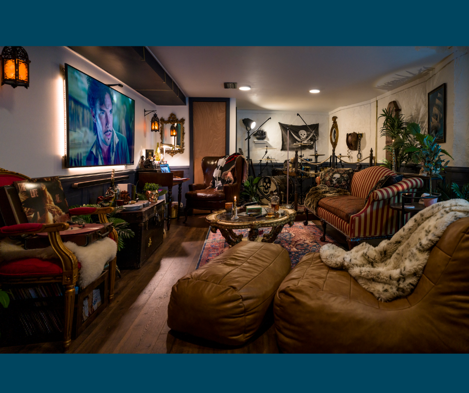 Finished basement by Smithers Home Maintenance with white walls, striped red accents, a faux fireplace, and a small holiday decoration in the corner.