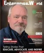 Close-up of a man with a beard and short hair, wearing a dark shirt, on a magazine cover titled 'Enterprise W orld'.