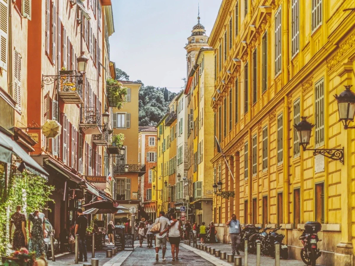 Pedestrian Street in Vieux-Nice lined with colorful buildings, cafés, balconies, and historic architecture.