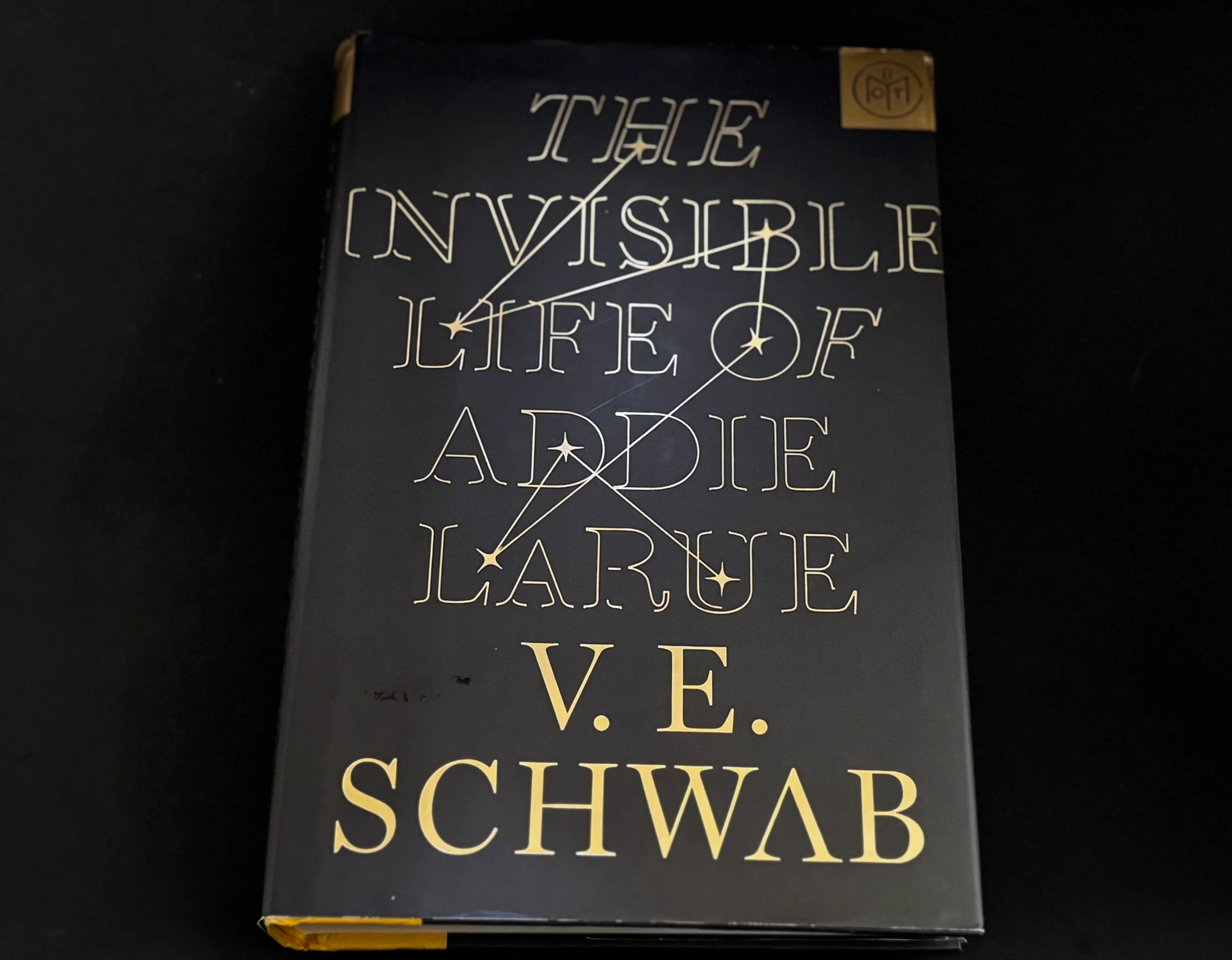 The Invisible Life of Addie LaRue by V.E. Schwab — gold lettering on black cover, paired with an Ólafur Arnalds literary playlist