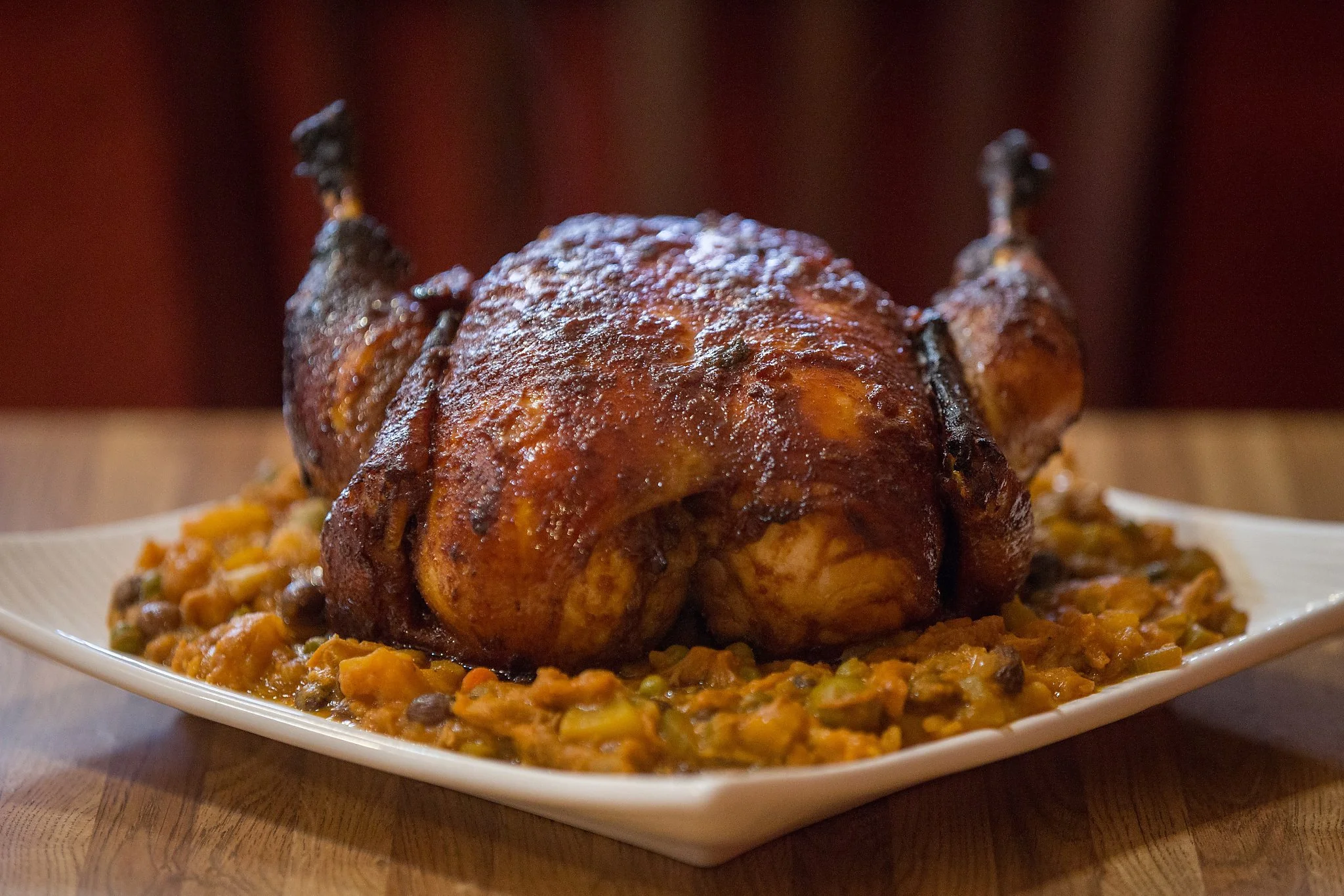 Golden roasted stuffed hen on a holiday with stuffing around