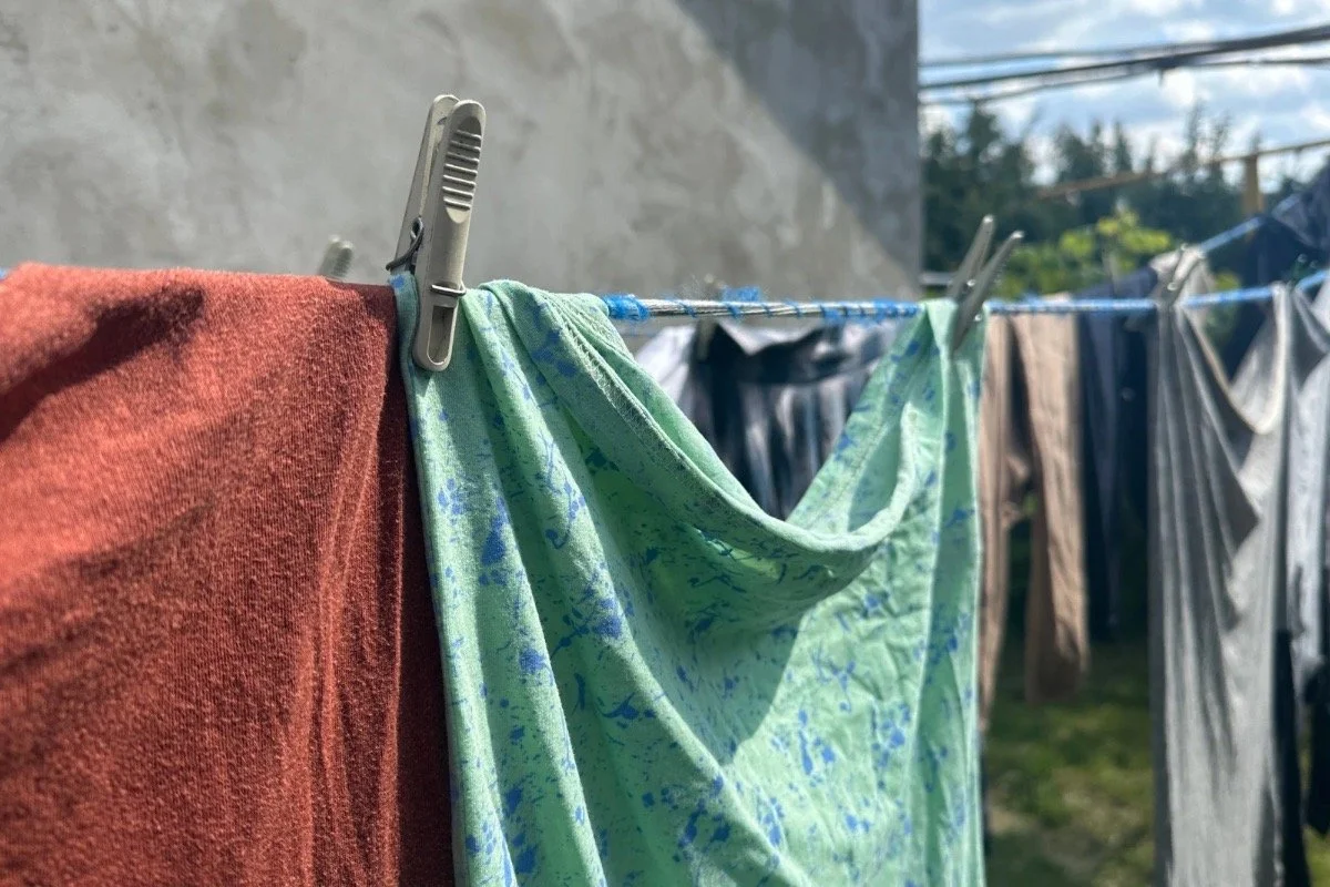 Clothing drying outdoors in spring light, representing gentle routines, body awareness, and intentional self-care.