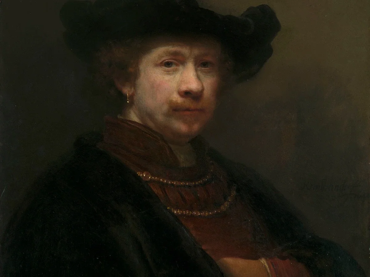 Rembrandt self-portrait featuring the artist in dark clothing and a black cap, painted with dramatic lighting and direct eye contact that emphasizes aging, vulnerability, and reflection.
