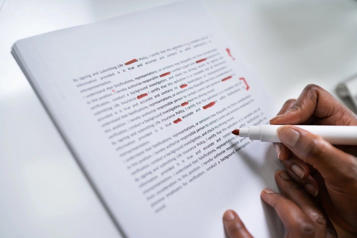 A marked-up manuscript being edited for a book-to-film adaptation, illustrating the transition from page to screen.