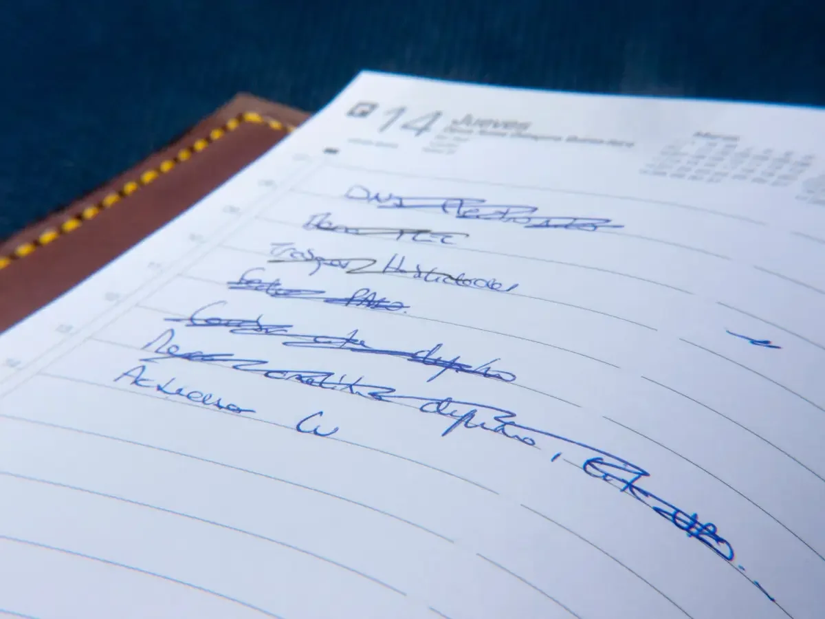 A handwritten song list with titles crossed out and reordered, a record of choices made along the way.