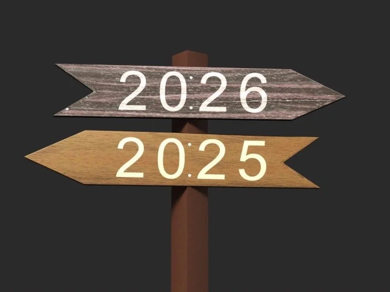 A wooden signpost with arrows labeled 2025 and 2026, symbolizing leaving the past year behind and stepping into a softer, intentional new year through micro-habits.