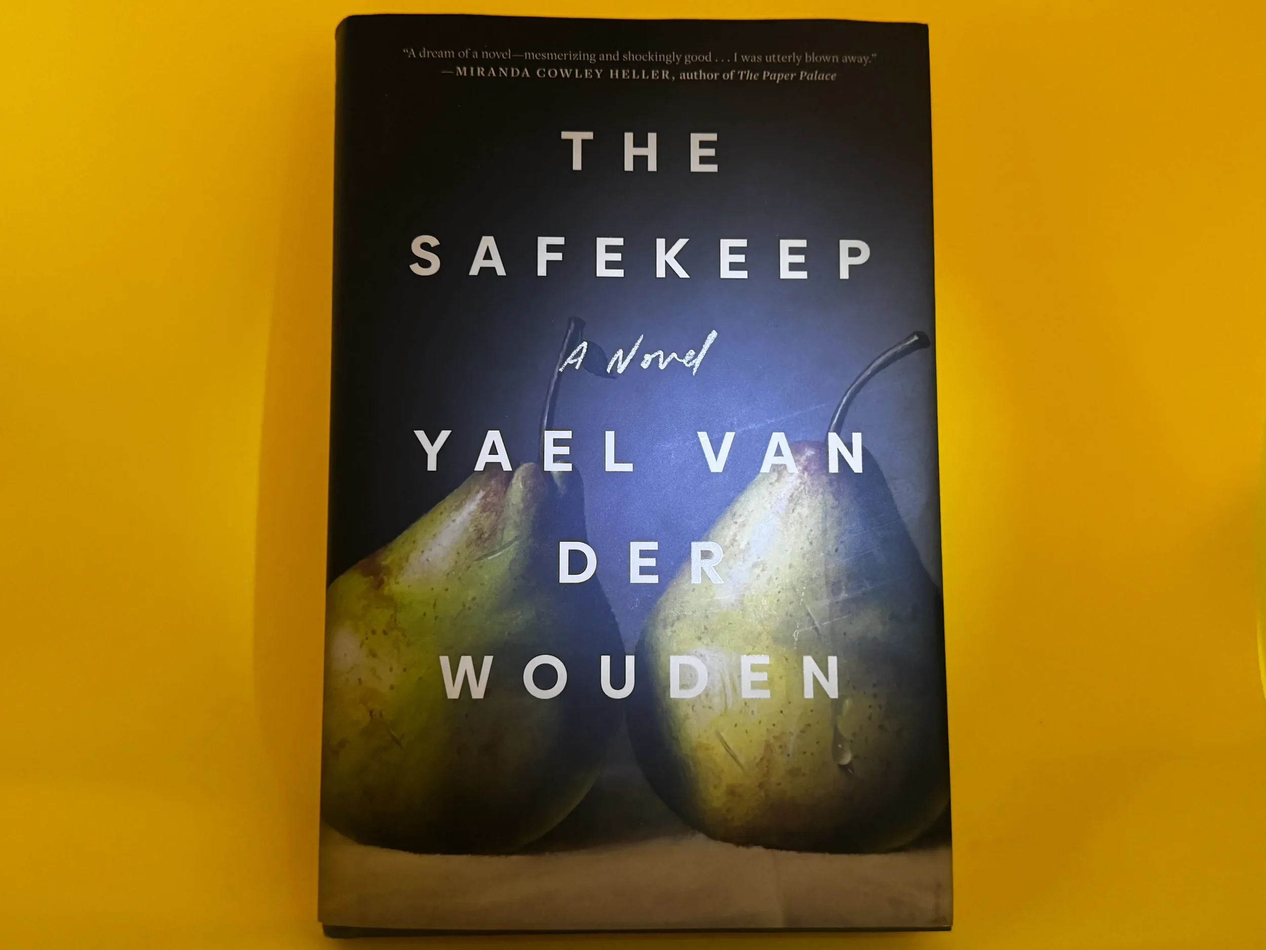 The Safekeep by Yael van der Wouden — dark cover with two pears on yellow background, literary playlist for the Booker-shortlisted novel