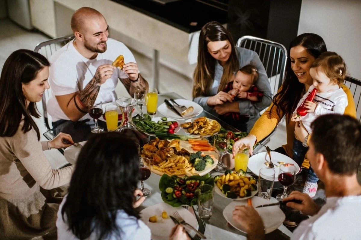 Family sharing a communal dinner representing food as cultural memory and coexistence in The Bastard of Istanbul.