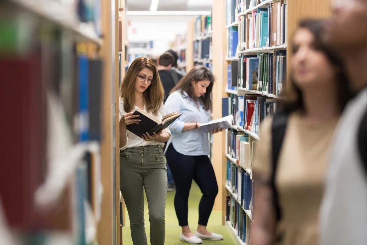 Women reading in a library, representing feminism and education themes in The Lion Women of Tehran