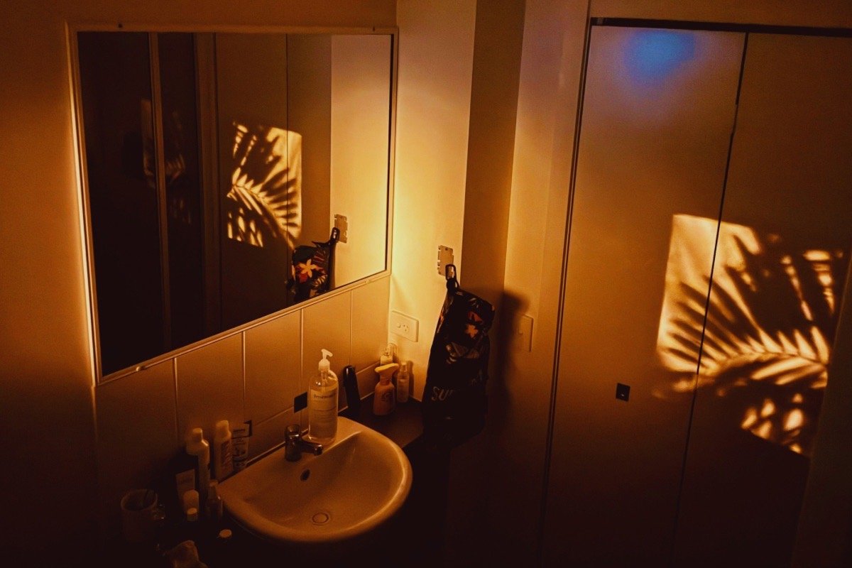 A quiet bathroom setting representing a gentle nighttime skincare routine designed to support skin barrier repair and recovery