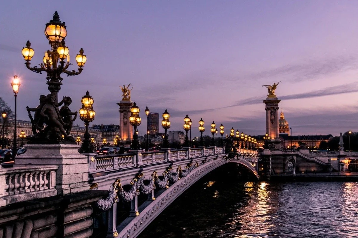 Paris bridge at dusk, reflecting memory, history, and timelessness in book-to-film adaptations