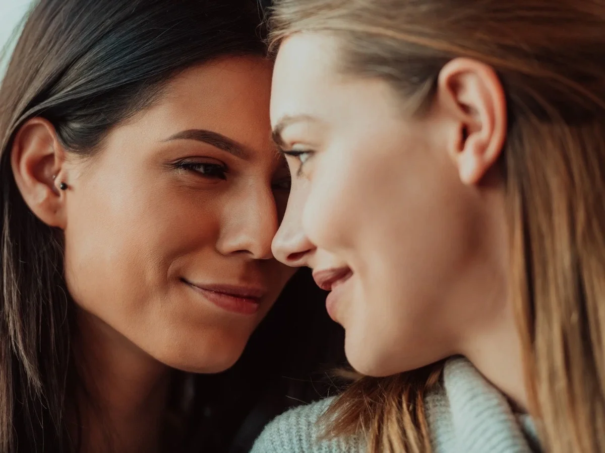 Two women sharing a close and intimate gaze, evoking themes of tenderness, secrecy, and emotional connection in queer cinema.