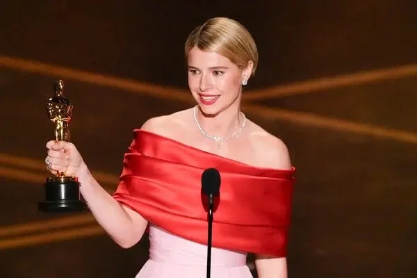 Irish actress Jessie Buckley holding the Best Actress Oscar for her performance in the film Hamnet during the Academy Awards ceremony