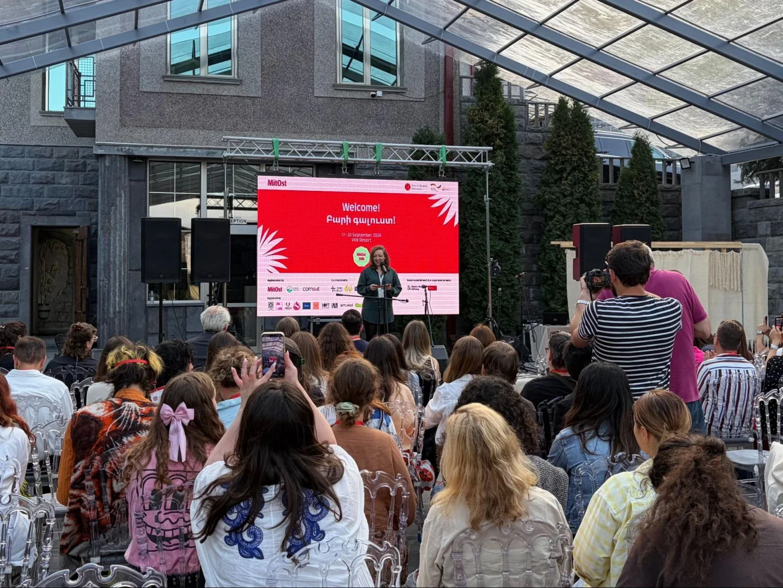 A speaker welcomes the audience at the MitOst event in Armenia.