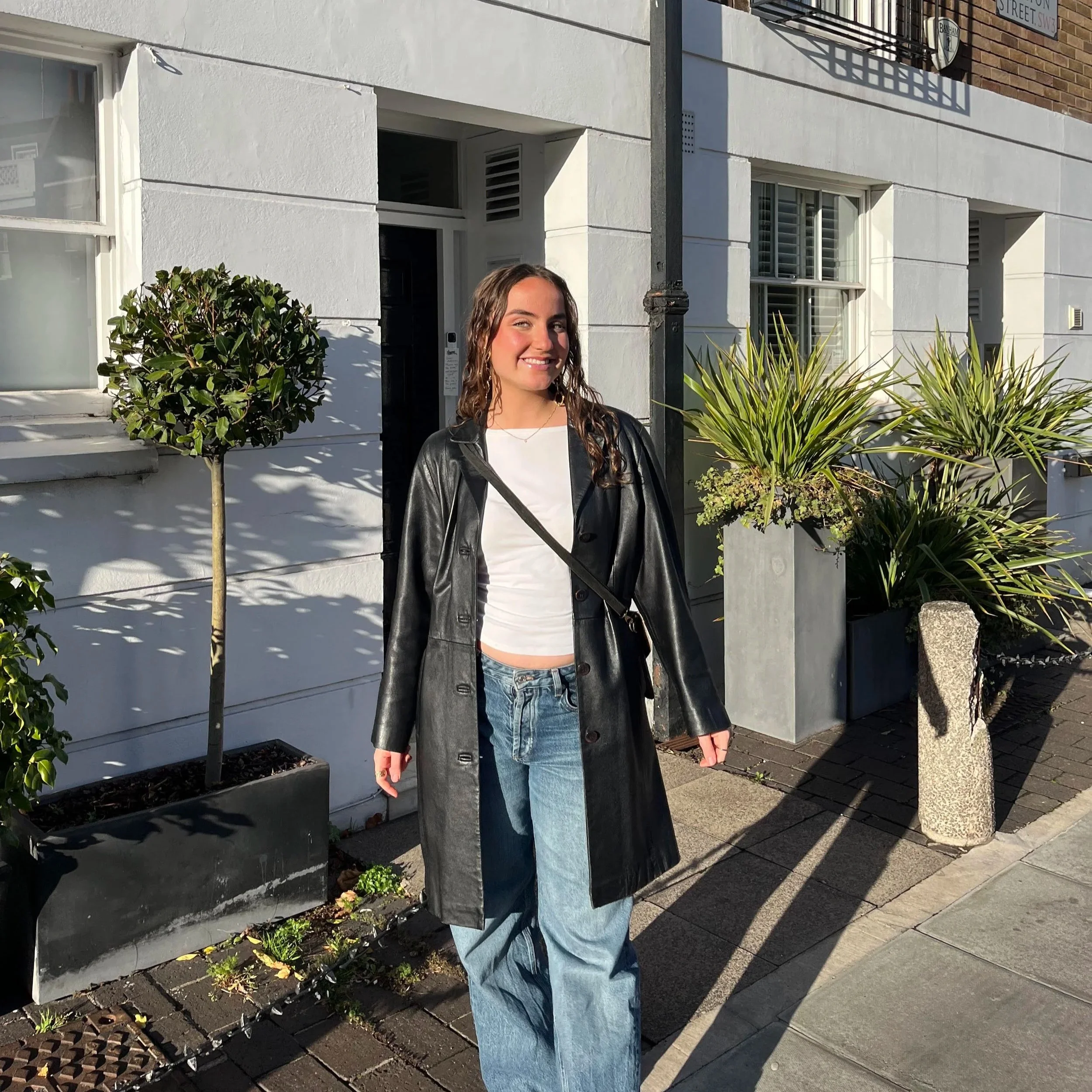 A girl standing outside and smiling