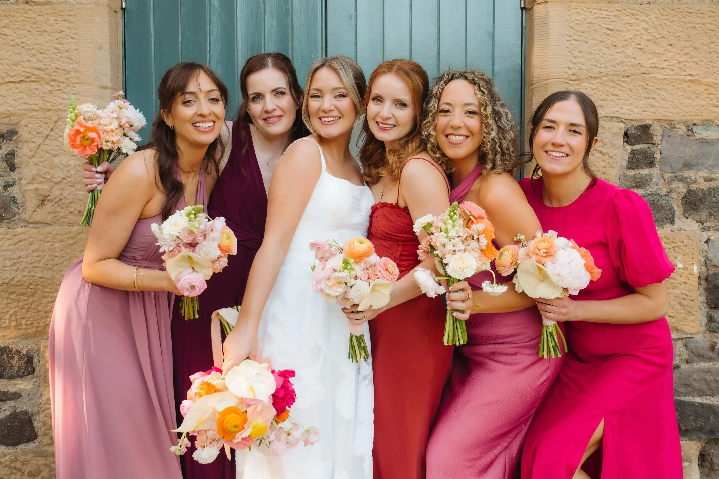 How gorgeous are Katy and her bridesmaids!?

This photo by @clairejulietpaton is too good not to share. Katy&rsquo;s perfectly curated colour palette of pinks, peaches, oranges and fuchsia throughout her dresses and flowers went pop against that famo