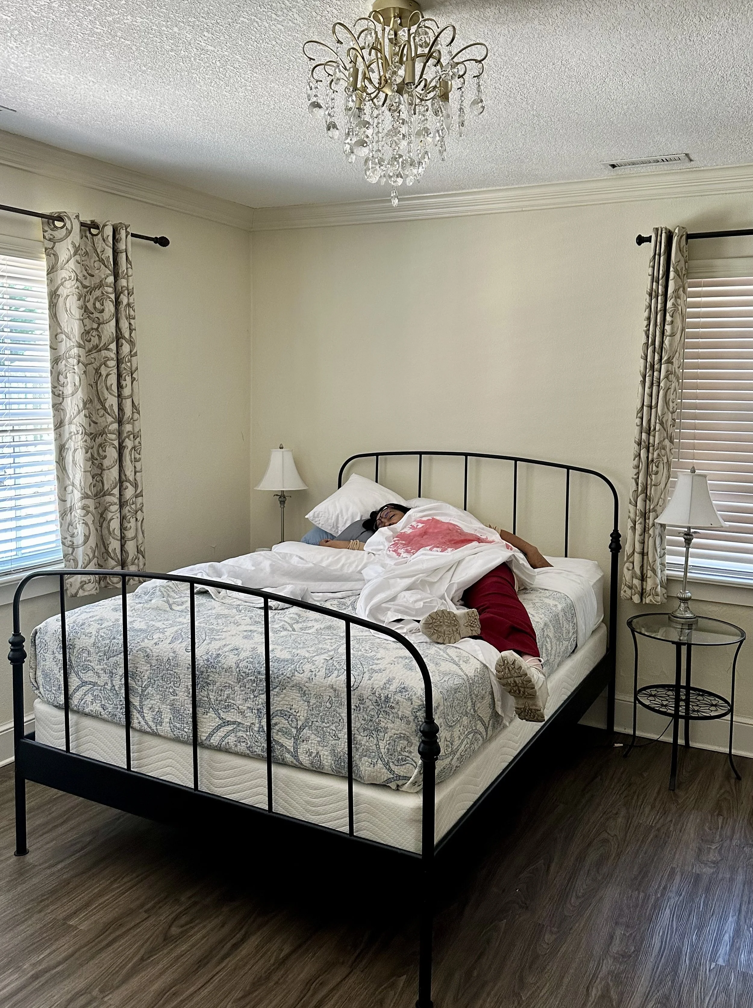 Woman on bed with bloody sheet