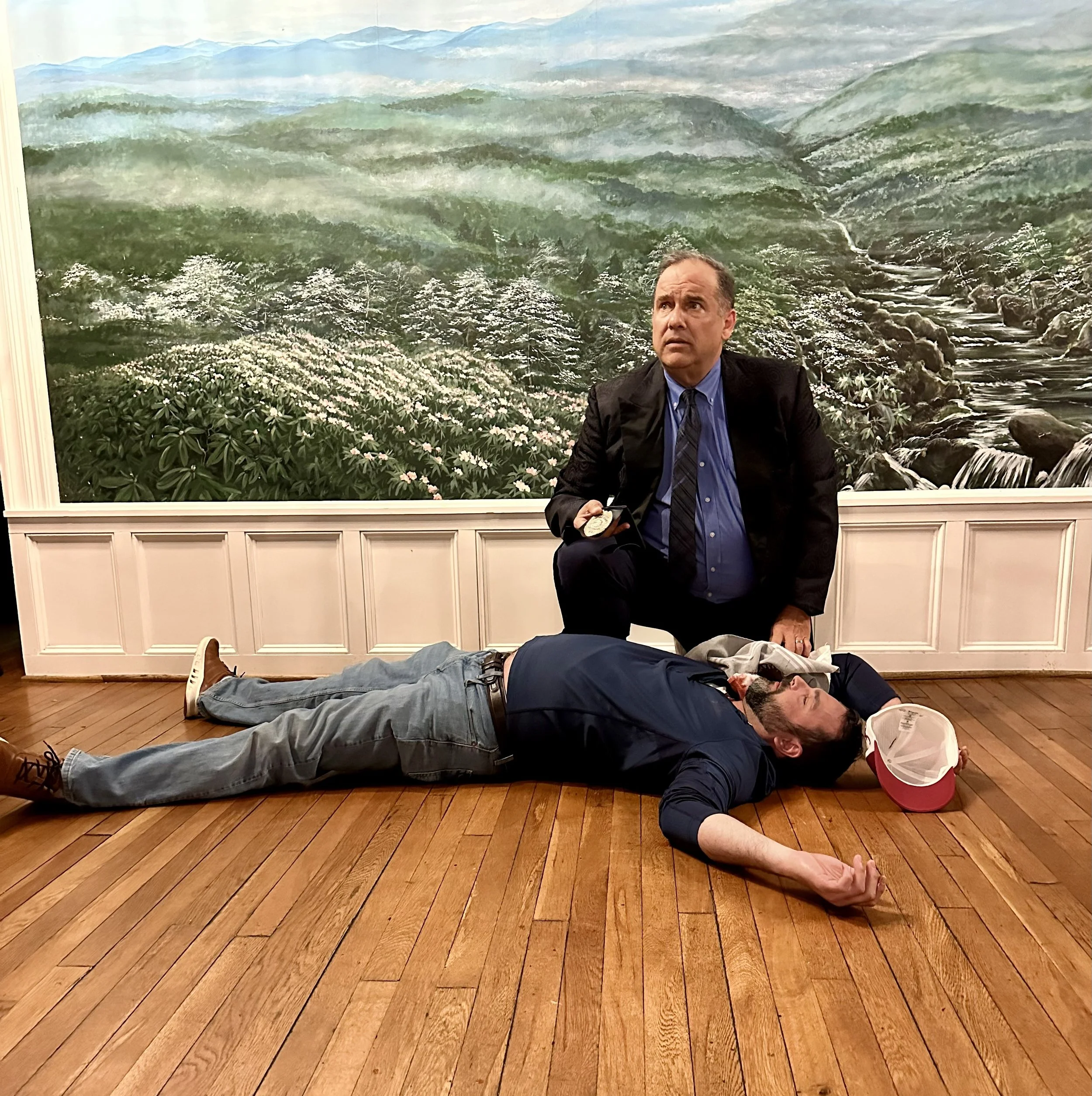 Detective kneeling over dead man