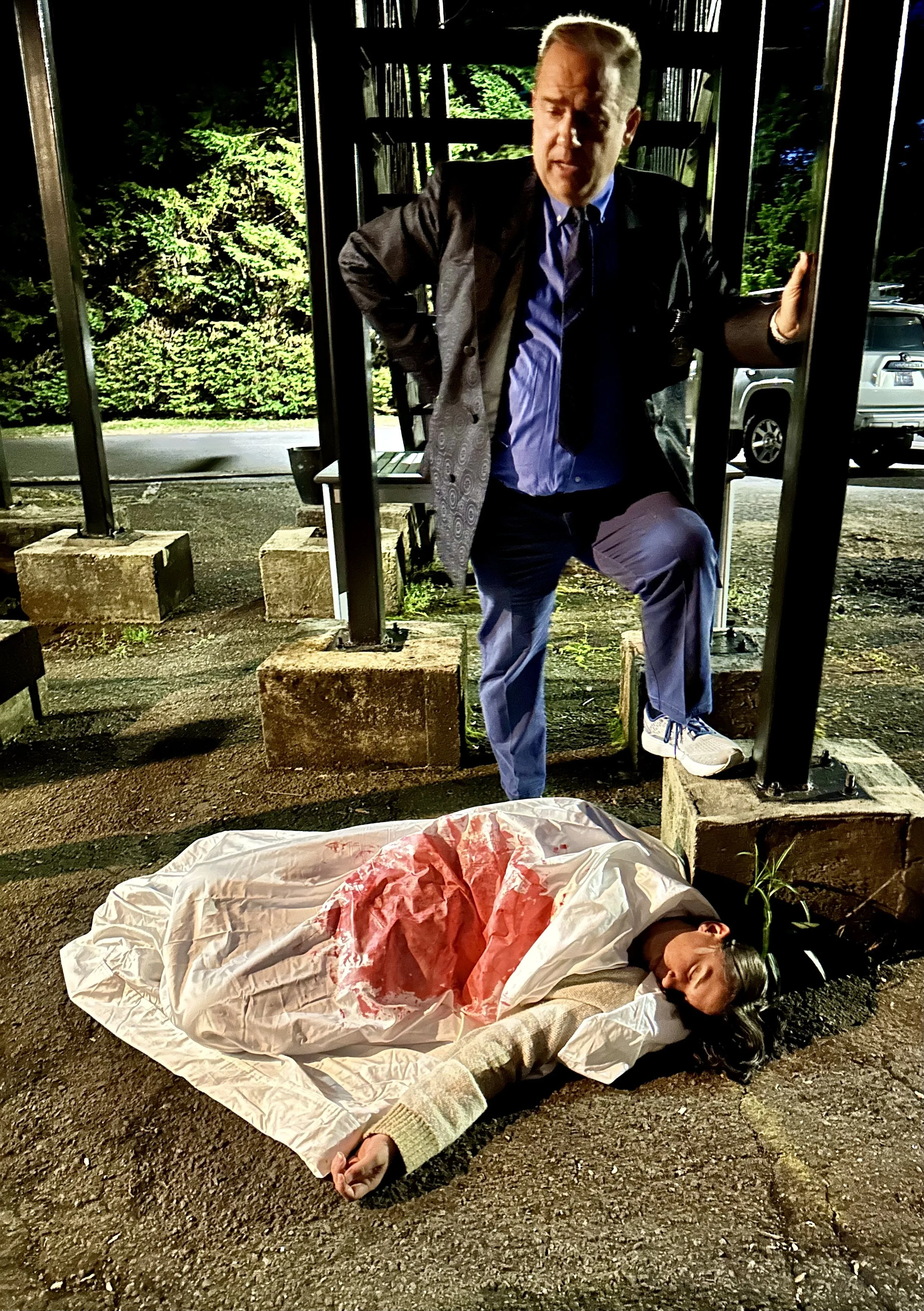 Detective standing over dead body