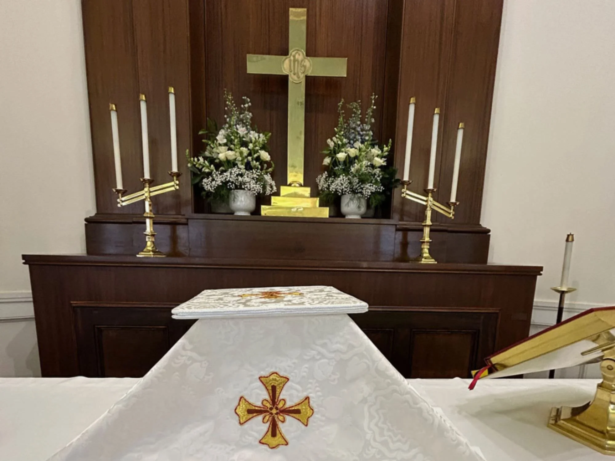 Episcopal altar with flowers, cross and candles